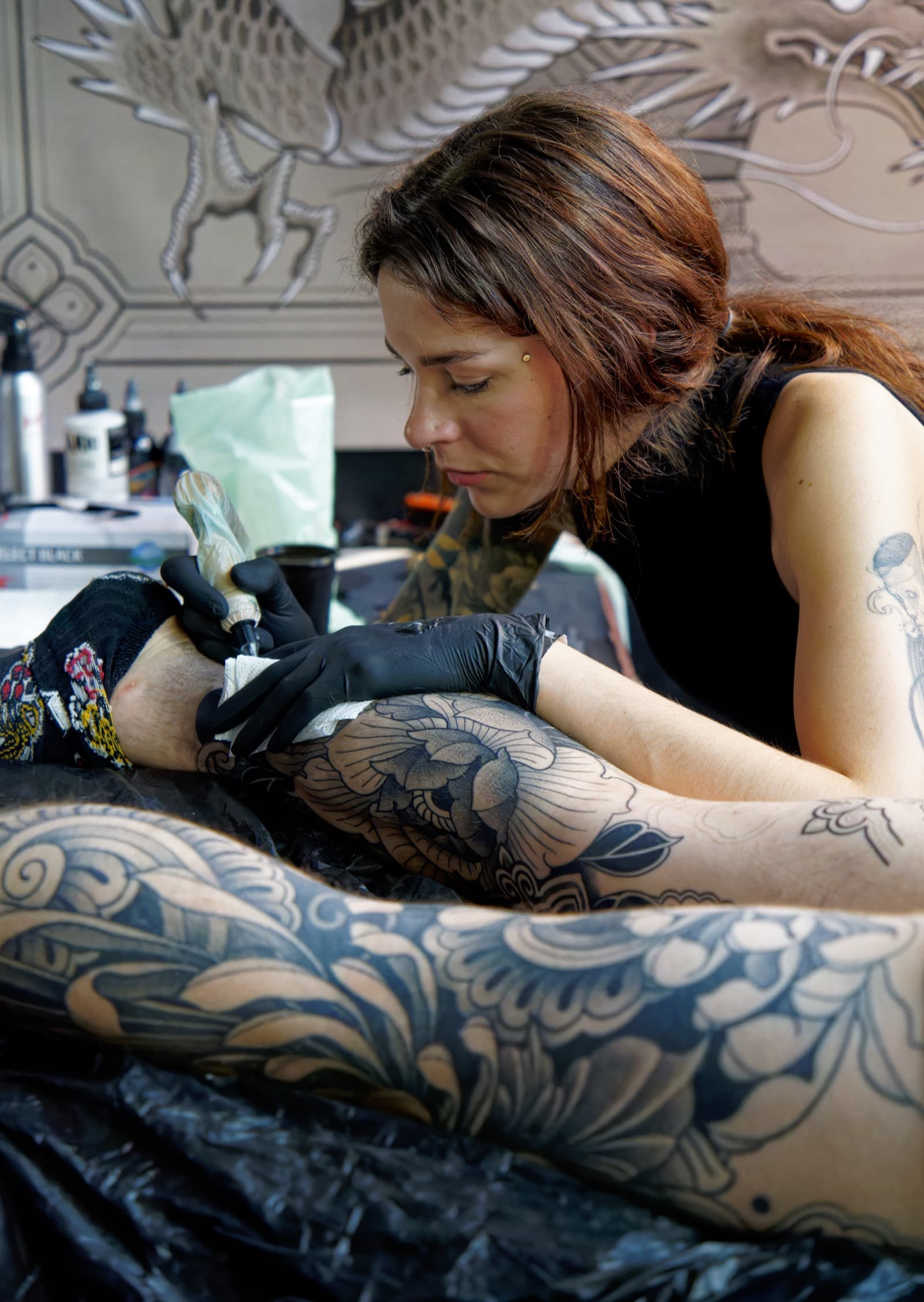 Tattoo artist working on fresh tattooed skin