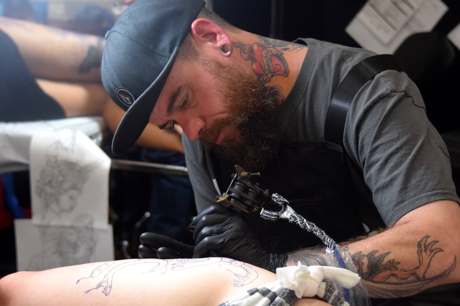 Tattoo artist working at a tattoo festival appointment